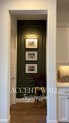 an open door leading into a kitchen with pictures on the wall and wood flooring