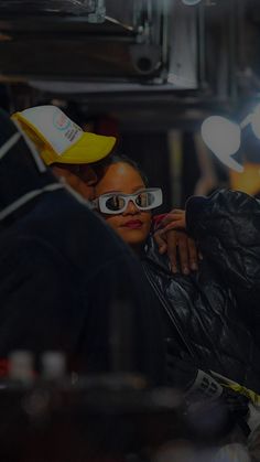 a man and woman wearing sunglasses are sitting together