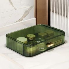 a green container sitting on top of a white counter