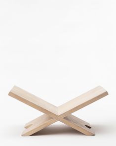 a wooden object sitting on top of a white surface