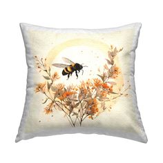 a white pillow with a painting of a bee on it's back and flowers