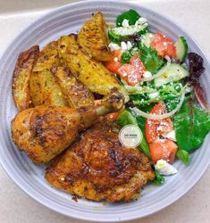 a white plate topped with chicken and vegetables