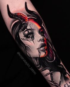 a woman's face with horns and makeup on her arm