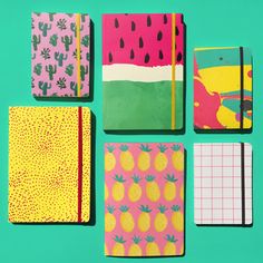 six notebooks lined up in different patterns on a green background with cactuses and pineapples