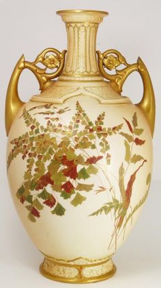 an ornate vase with gold trimming and painted leaves