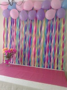 balloons and streamers are hanging over a table