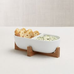 a white bowl filled with bread and dip