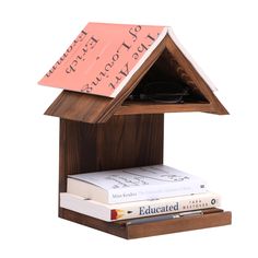 a book shelf with books and a note attached to it