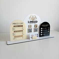 three different types of business cards on a white counter top, with price list and prices listed