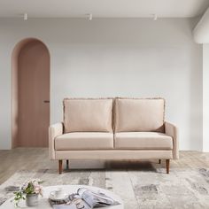 a living room with a couch, table and vases on the floor in front of it