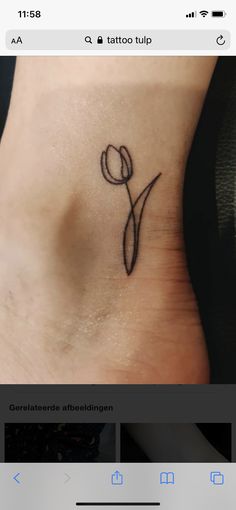 a small tattoo on the foot of a woman's lower body, with a single flower