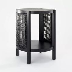 the side table is made from black wood and has an intricate pattern on it's surface