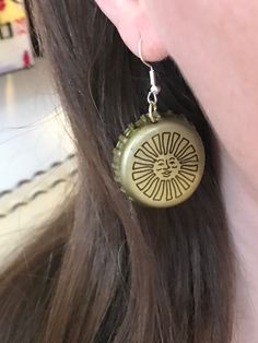 a close up of a person's ear with a pair of earrings on it