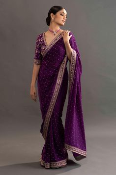 Violet crepe saree with all over buttis and zari embroidered border. Comes with embroidered blouse. Component: 2 Pattern: Embroidered Type Of Work: Floral Neckline: V neck Sleeve Type: Elbow length Fabric: Crepe Color: Purple Other Details: Zari embroidered border Occasion: Reception,Wedding - Aza Fashions Luxury Purple Saree With Weaving Work, Luxury Purple Georgette Saree, Luxury Purple Chanderi Saree, Luxury Purple Saree With Intricate Embroidery, Luxury Purple Pre-draped Saree With Zari Work, Luxury Purple Saree With Border, Luxury Purple Pre-draped Saree For Diwali, Luxury Purple Saree Gown, Luxury Embroidered Purple Pre-draped Saree