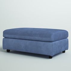 a blue footstool sitting on top of a white floor