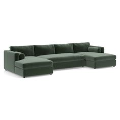 a green sectional couch sitting on top of a white floor