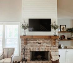 a living room with a fireplace and television mounted above the mantel in front of it