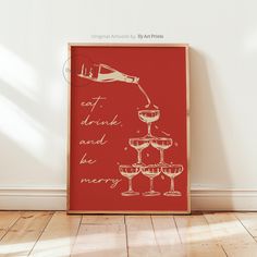 a red poster with champagne being poured into wine goblets on it's side