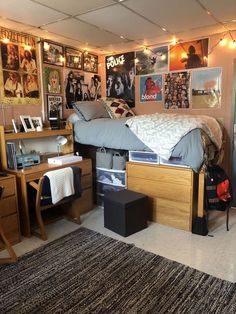 a bed room with a neatly made bed and lots of pictures on the wall