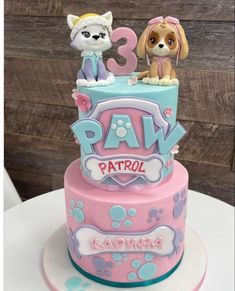 a pink and blue birthday cake with two dogs on top that says paw patrol, kawaia's