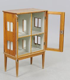 an open wooden cabinet with multiple compartments and doors on each side, in front of a white background