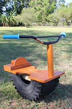 a wooden scooter sitting in the grass