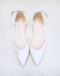 a pair of white shoes on top of a table