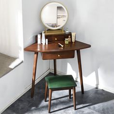 a wooden desk with a mirror and stool