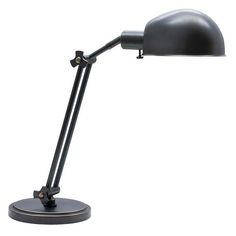 a black desk lamp on a white background with clippings to the side and one light turned on