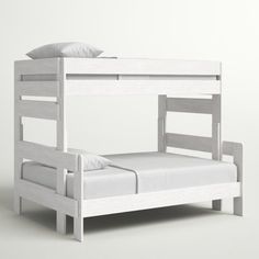 a white bunk bed sitting next to a white pillow on top of a bed frame