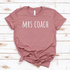 mrs coach shirt, coach wife tshirt, coach wife gift, coachs wife, coach shirt, wife shirt UNISEX T-SHIRTS Short sleeve Unisex T-shirt - 100% combed and ring-spun cotton (fiber content may vary for different colors) - Light fabric - Tear away label - Runs true to size SIZING AND COLORS - Please refer to size chart on the listing photos in every listing for a detailed sizing chart with measurements. - We use soft and fitted unisex T-shirts from Bella Canvas that are in standard men's sizes.  - Women will typically need to order one size down SHIPPING AND PRODUCTION TIME - Production: 1-3 days - Standard Shipping: 3-5 business days after production time HOW TO ORDER - Choose your shirt color - Choose your size - Verify all order information is correct FEEDBACK - If anything is wrong with your Coachs Wife, Coach Wife Shirt, Coaches Wife Shirt, Wife Shirts, Coaches Wife, Coach Shirt, Coach Shirts, Wife Gift, Sizing Chart