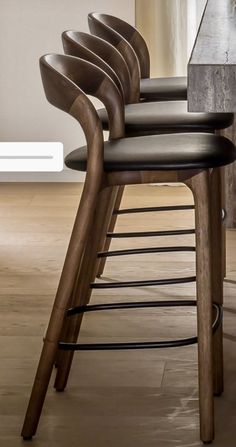 a row of chairs sitting on top of a hard wood floor next to a counter