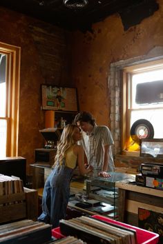 a man and woman looking at records in a room