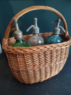 three soap dispensers in a wicker basket