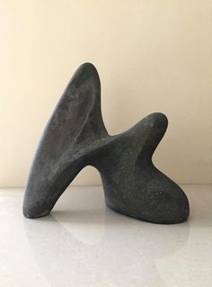 a black sculpture sitting on top of a white counter