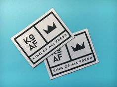 two king of all fresh stickers sitting on top of a blue surface with black and white lettering