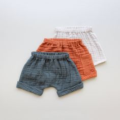 three pairs of baby boys'shorts on a white background