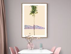 a white table with pink chairs and a painting hanging on the wall above it,