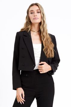 This cropped blazer presents the perfect blend of professional and contemporary style with this double breasted cropped blazer. Cut for a flattering silhouette, it features a notched lapel and sleek open front design. Upgrade any look with sophisticated chic. Cropped blazer Double breasted Notched lapel Self: 92% Polyester, 8% Spandex Lining: 93% Polyester, 3% Spandex Length: 18 3/4" Chest: 18 1/2" Hand wash in cold water. Lay flat to dry. Model is wearing a size small Style #: F236J1645 Black Notch Lapel Cropped Jacket For Business, Fitted Black Cropped Single Breasted Jacket, Cropped Black Blazer, Luxury Black Cropped Blazer, Black Cropped Blazer With Button Closure, Blazer Crop, Black Single-breasted Cropped Jacket With Lapel Collar, Grey Maxi Skirts, Luxury Outerwear