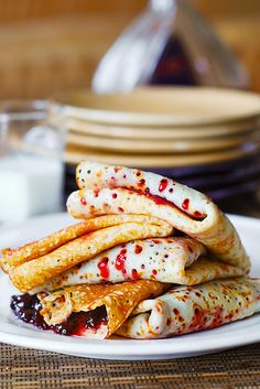 a stack of pancakes sitting on top of a white plate