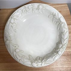 a white plate sitting on top of a wooden table