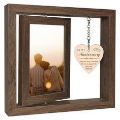 an anniversary photo frame with a keychain hanging from it's front and back