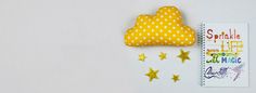 a notebook with a yellow polka dot cloud and stars on it next to a notepad