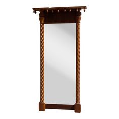 a tall wooden mirror sitting on top of a white wall