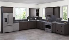 a modern kitchen with stainless steel appliances and wood flooring