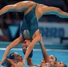 two women are doing acrobatic tricks in the water