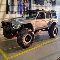 an off - road vehicle is parked in a garage