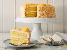 a slice of cake on a plate next to the rest of the cake and fork