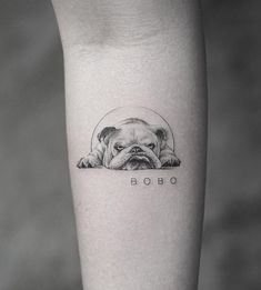 a small pug tattoo on the left inner forearm and leg, with an inscription bob