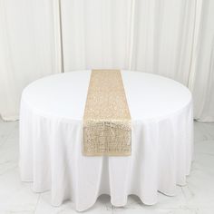 a white table topped with a gold runner